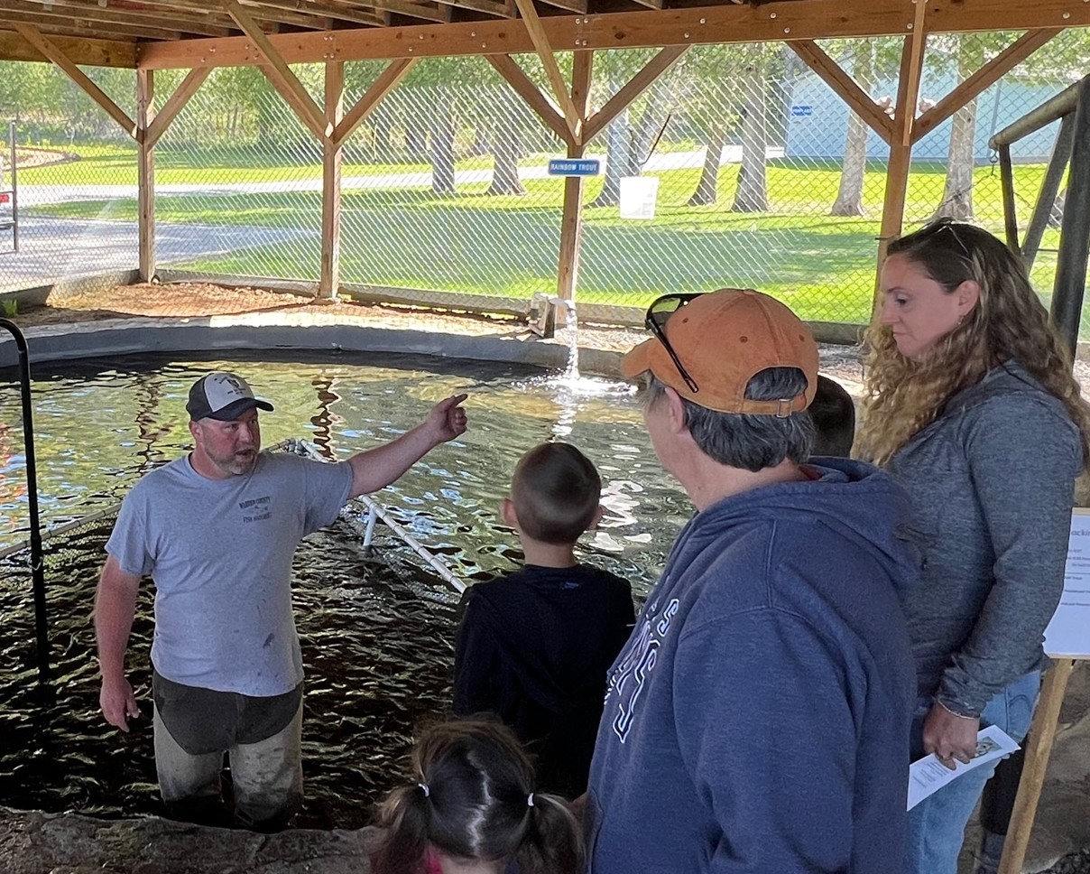 Warren County Parks and Rec director Jeff Inglee talks to a group of visitors at Warren County fish hatchery