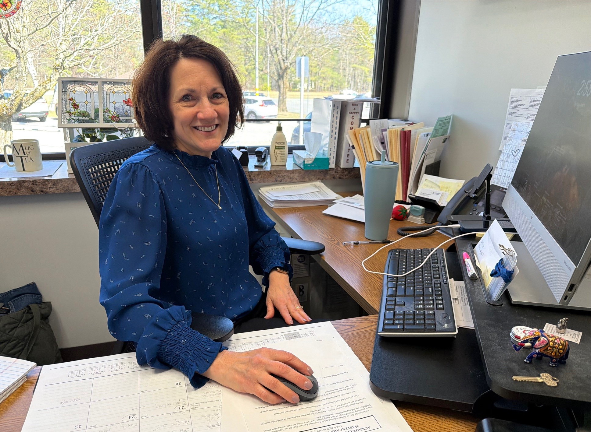Picture of Patricia Belden, new director of Health Services, sitting at her desk at Warren County Public Health