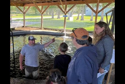 Warren County Parks and Rec director Jeff Inglee talks to a group of visitors at Warren County fish hatchery