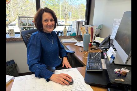 Picture of Patricia Belden, new director of Health Services, sitting at her desk at Warren County Public Health