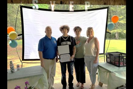 Photo caption -- from left, Assemblyman Matt Simpson, Ryder Carlton, Liza Ochsendorf and Traci Ross, Executive Director of Adirondack Folk School at 2026 Summer Youth Employment Program picnic on Thursday, August 13, 2026.)